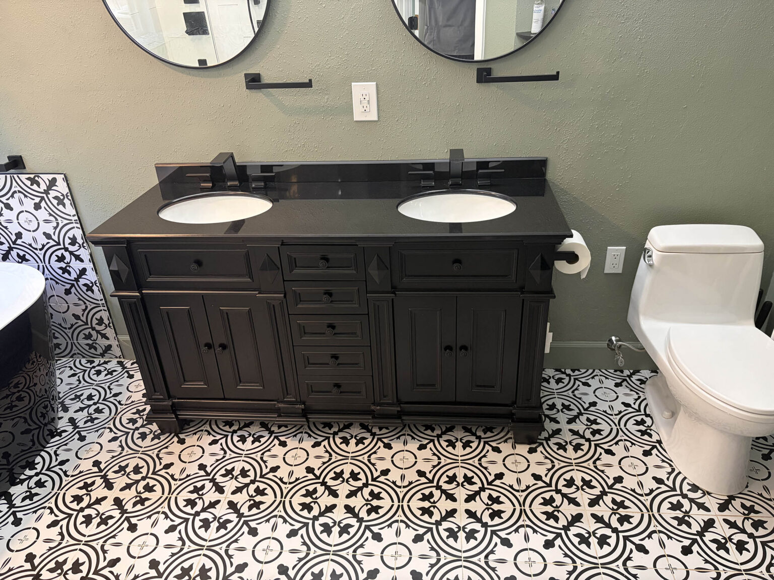 Double vanity bathroom with black-and-white patterned tile after a deep clean