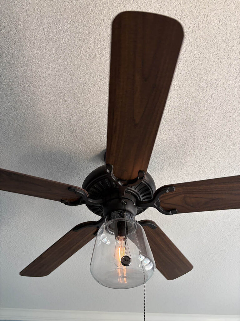 Ceiling fan blades wiped clean after an Open Hands deep clean