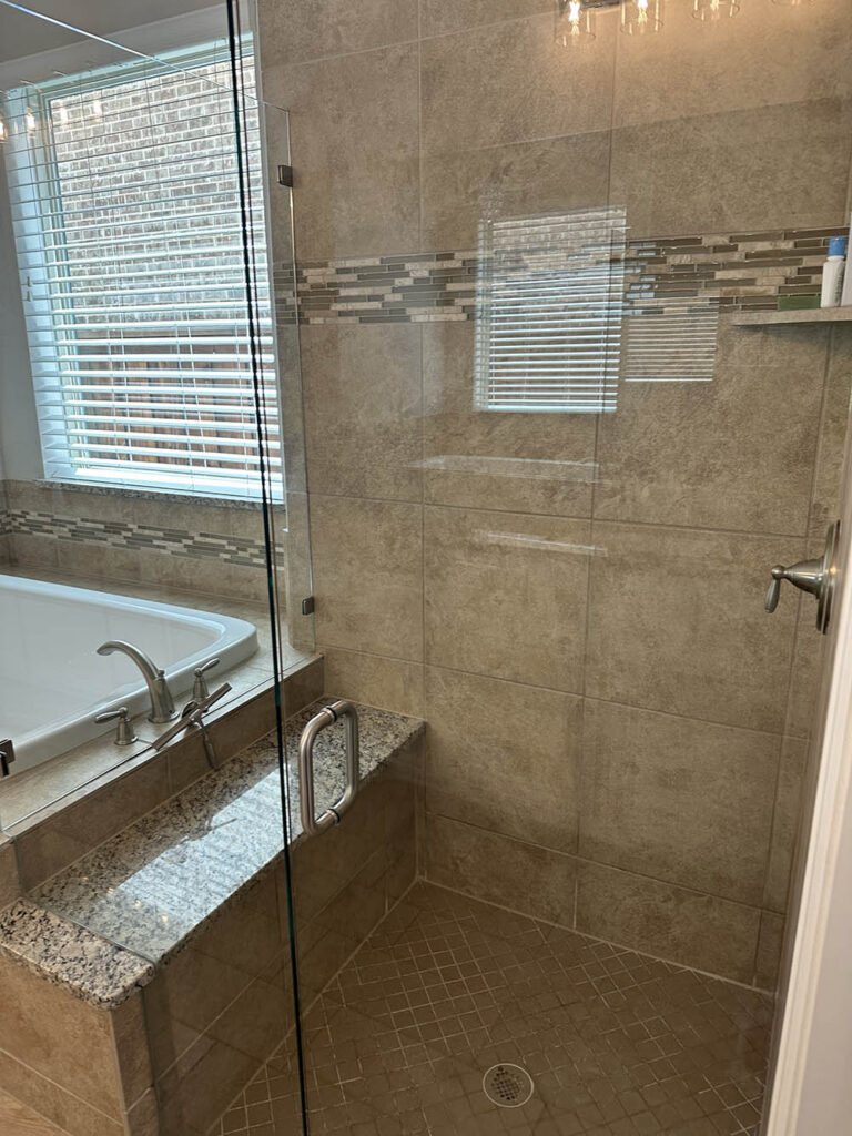 Glass shower with a tile surround after a deep clean