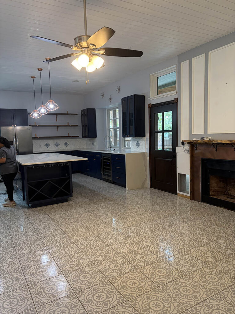 Open kitchen and living room with patterned tile floor after a move-in clean