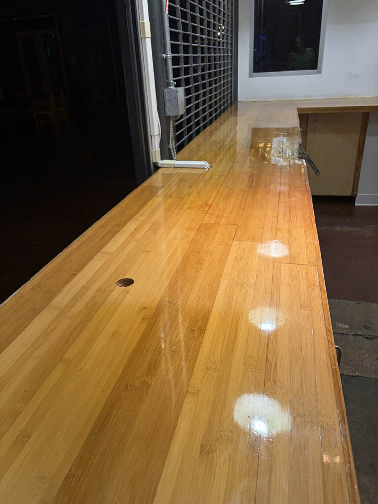 Polished bamboo service counter after commercial cleaning
