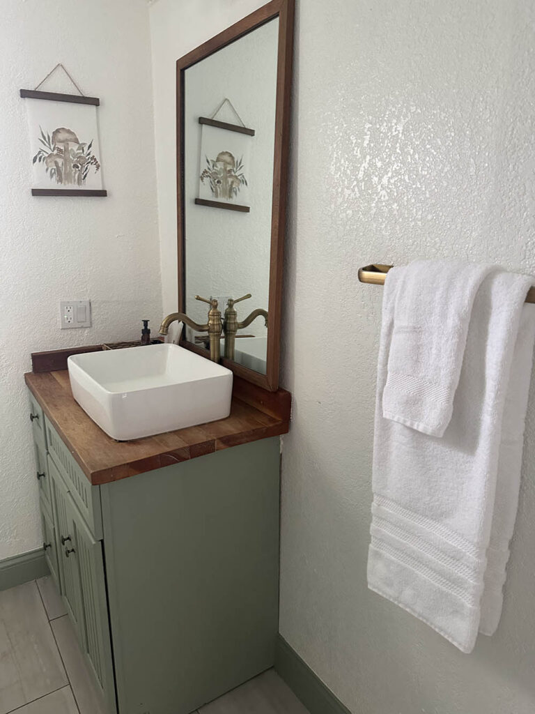 Powder room with a vessel sink and fresh towels ready for guests