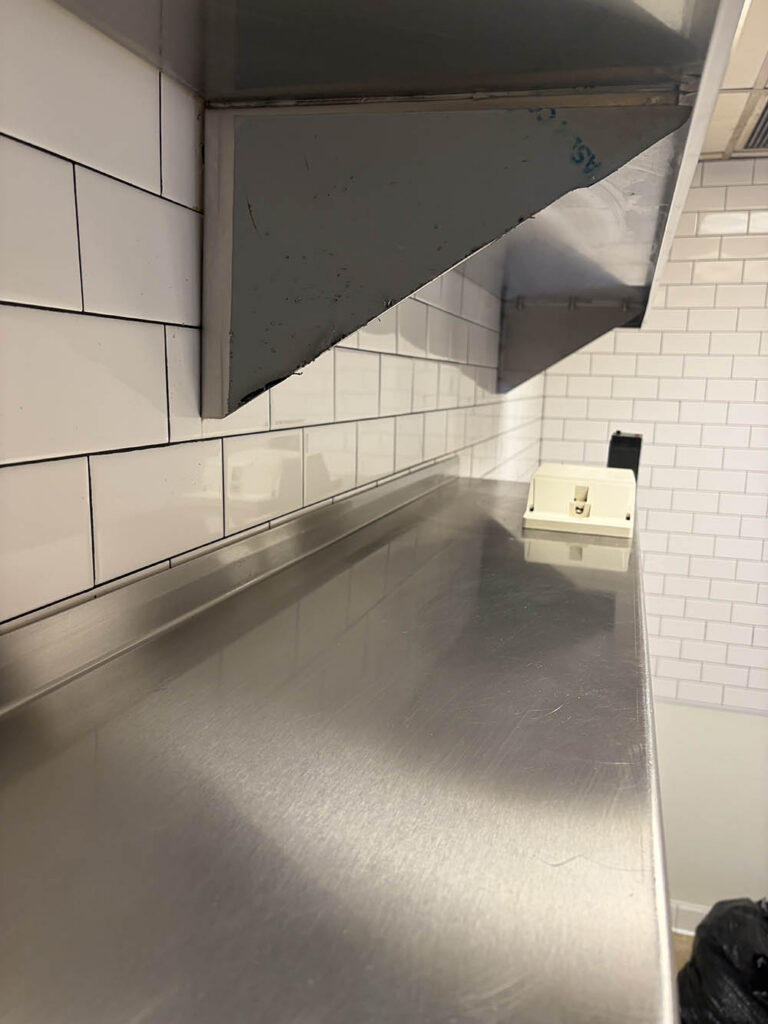 Stainless prep counter and subway tile after commercial cleaning