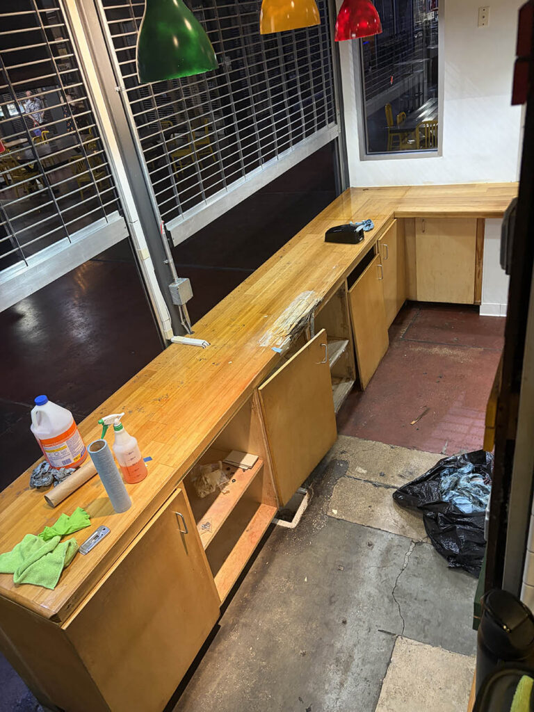 Commercial counter mid-clean with supplies and microfiber cloths