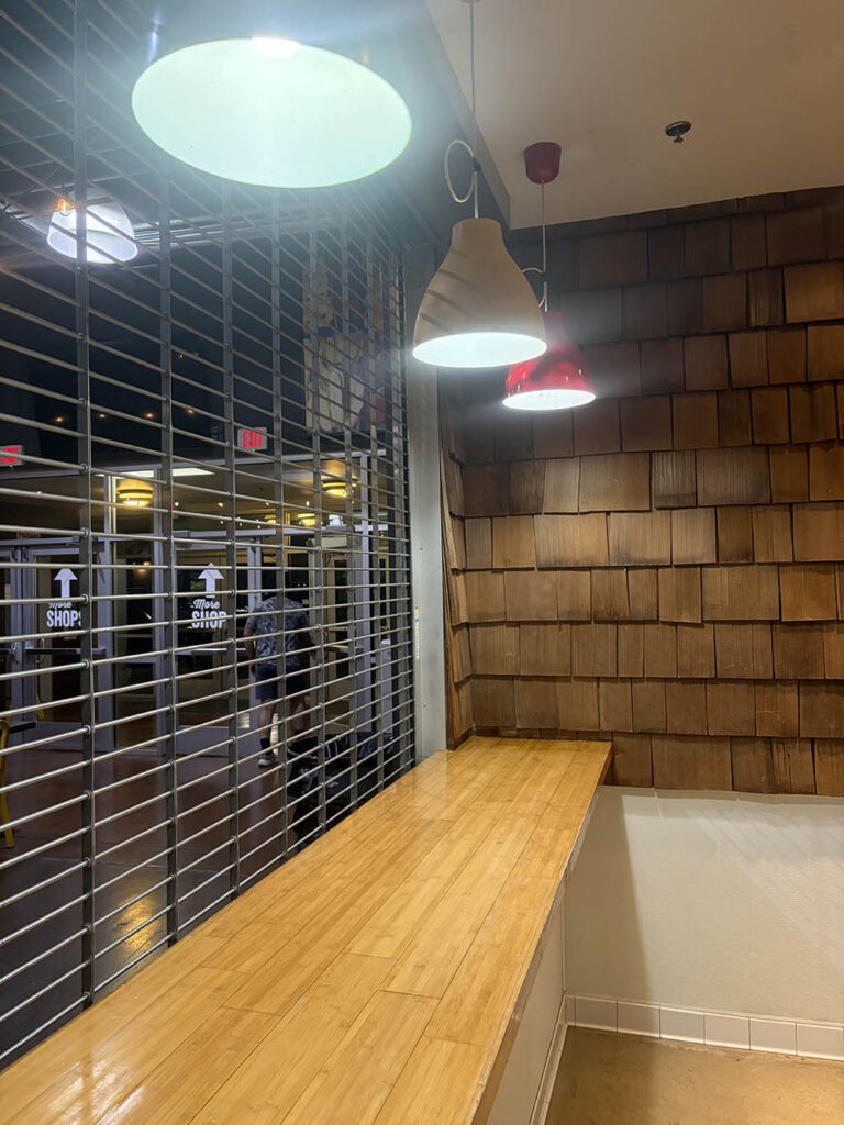 Commercial service counter behind a security gate before cleaning