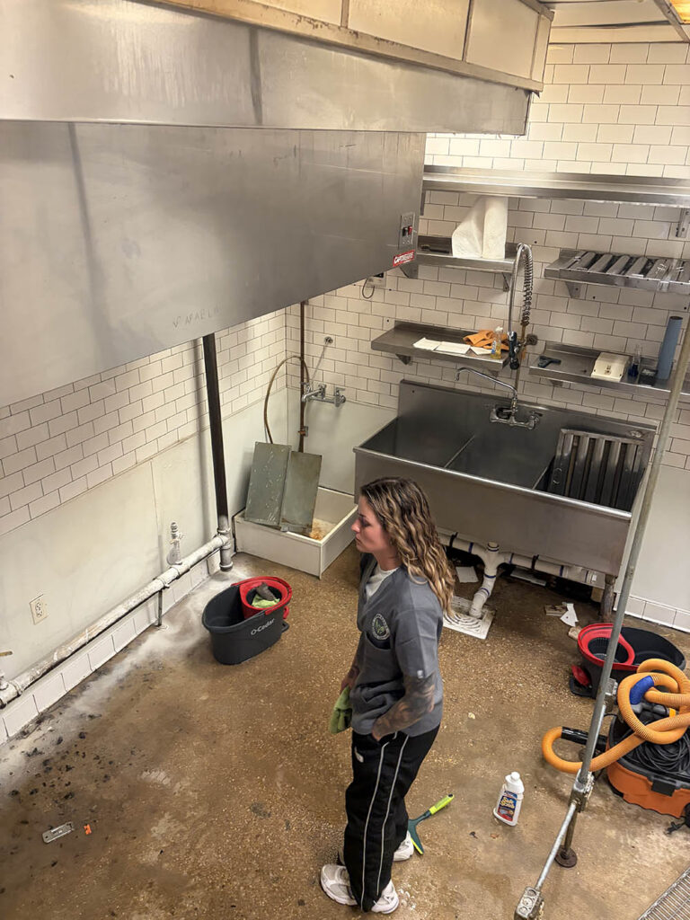 Open Hands crew member cleaning a commercial kitchen