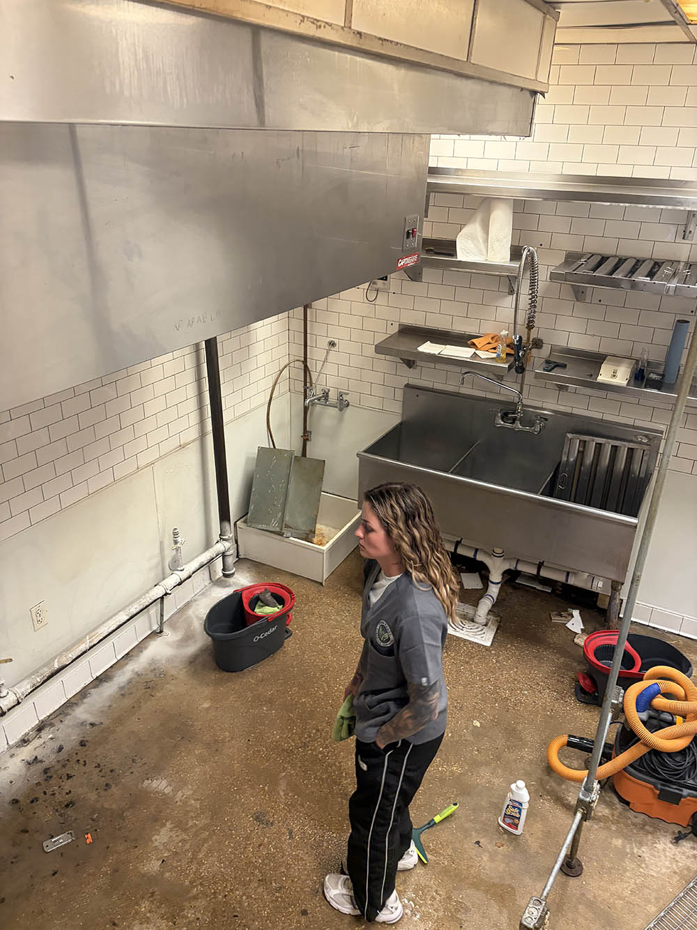 Open Hands crew member cleaning a commercial kitchen