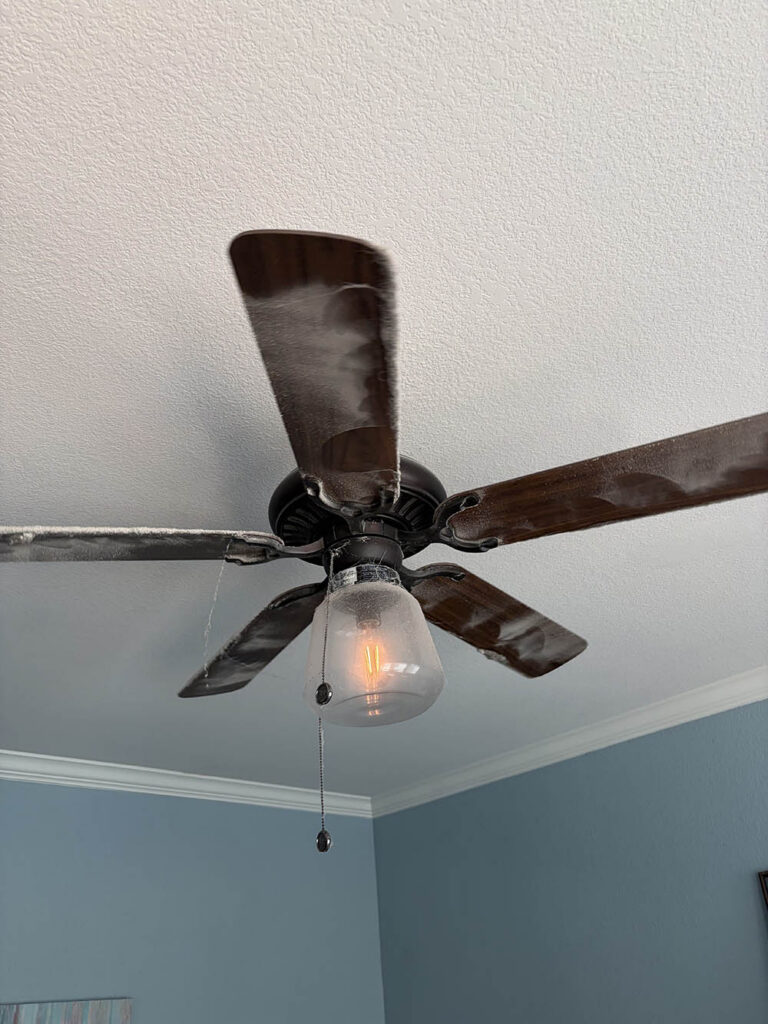 Dusty ceiling fan blades before an Open Hands deep clean